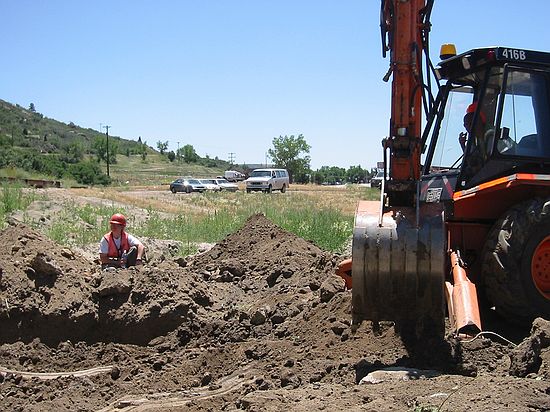 One of the best paleontology tools known to mankind - the backhoe!  Beth Ellis directs at left.