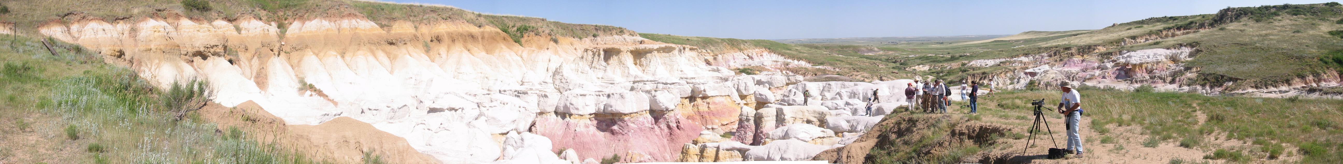A panoramic of 11 separate digital images stitched together to show the full beauty of the Calhan Paint Mines.  Dave Basinger (DMNS photographer) setting up in foreground.