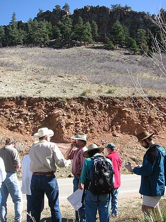 Stop #3 (10:45 a.m.) - Lyons formation at top of hill beyond trees.  Roadcut in foreground is a more modern debris flow.  We know it's a debris flow because the larger rocks and boulders are on the top with the fine grained material below.  This is common in debris flows and avalanches.