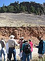 Stop #3 (10:45 a.m.) - Lyons formation at top of hill beyond trees.  Roadcut in foreground is a more modern debris flow.  We know it's a debris flow because the larger rocks and boulders are on the top with the fine grained material below.  This is common in debris flows and avalanches.