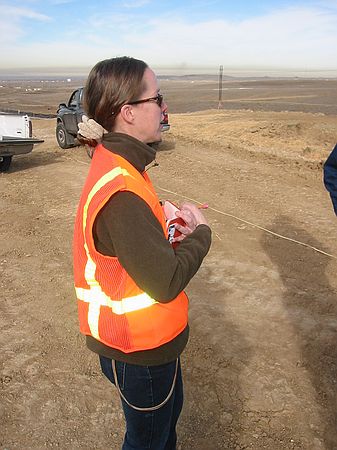 Jennifer Haessig (Rocky Mountain Paleontology) discussing past findings at the site and taking field notes.