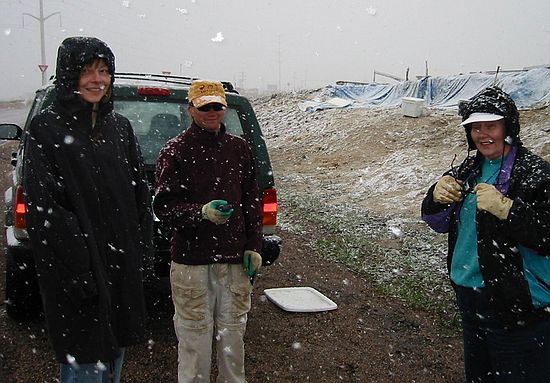 The snow begins to fall heavily as Susan Passmore (left) arrives to dig.  A light snow wouldn't have bothered us.  After all, snow is better than rain... but this?!  The quarry is jinxed!  Center: Rich Barclay, Right: Shirley Alvarez.(4/23/03)