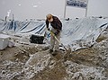Rich Barclay continues digging trench, convinced the snow will end soon. (4/23/03)